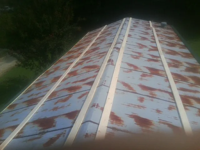 Rusted metal roof panels with new wood purlins before replacement — Storm Damage Roof Repair in Boiling Springs by Roofing Brothers